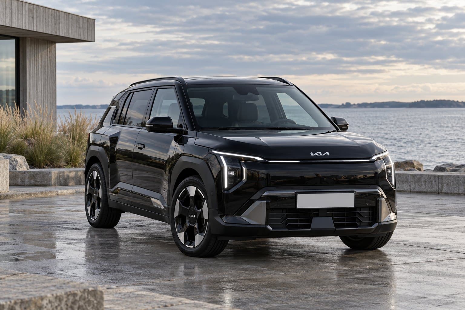 Black Kia EV3 by the seaside, front three-quarter view