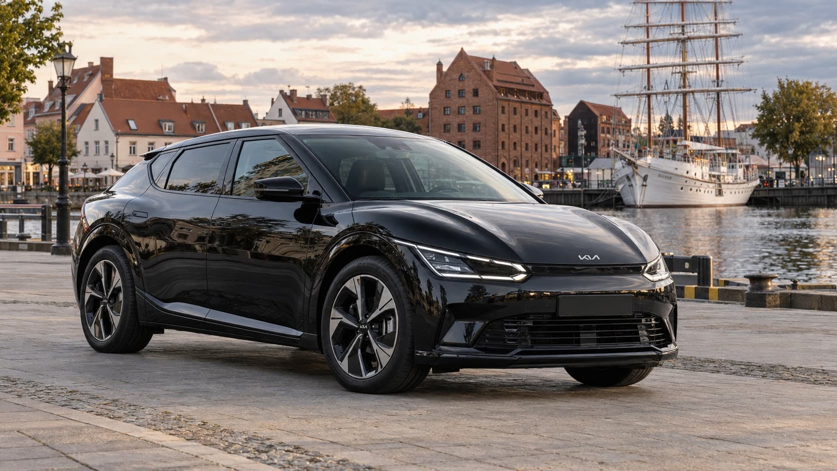 Black Kia EV6 by the Danė river in Klaipėda Old Town